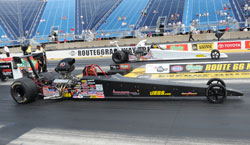 Samantha Kenny drives the black dragster in the NHRA Super Comp class