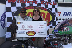 Drag Racing's Don Gatlin collects his $1,000 check.