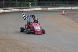 Carrying a checkered flag for her victory lap is a comfortable position for the 15-year-old teenager, one she plans on repeating again in 2011 in her new winged 270.