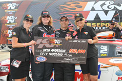 Stephanie Dunn and NHRA Pro Stock driver Greg Anderson accept Greg's winning check